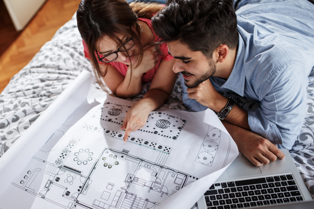 Pareja revisando planos para elegir casa en la Zona de la Cantera.